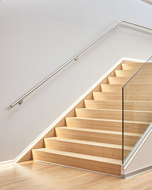 Modern staircase with glass railing utilizing Bothbest solid bamboo treads and risers