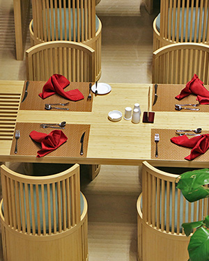 Luxury hotel restaurant fitted with custom bamboo panel dining furniture and wall pillars